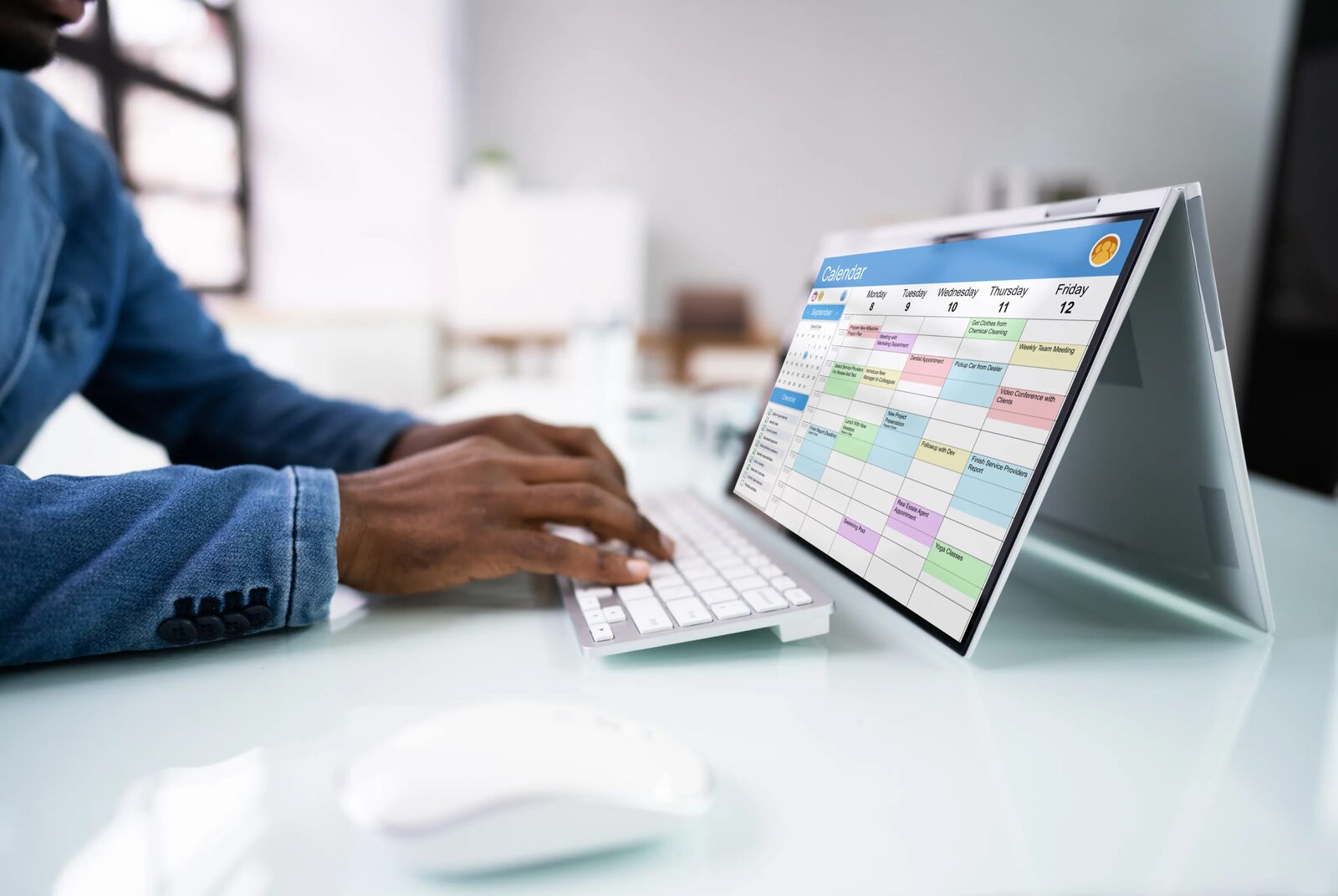 A weekly schedule being planned on a laptop