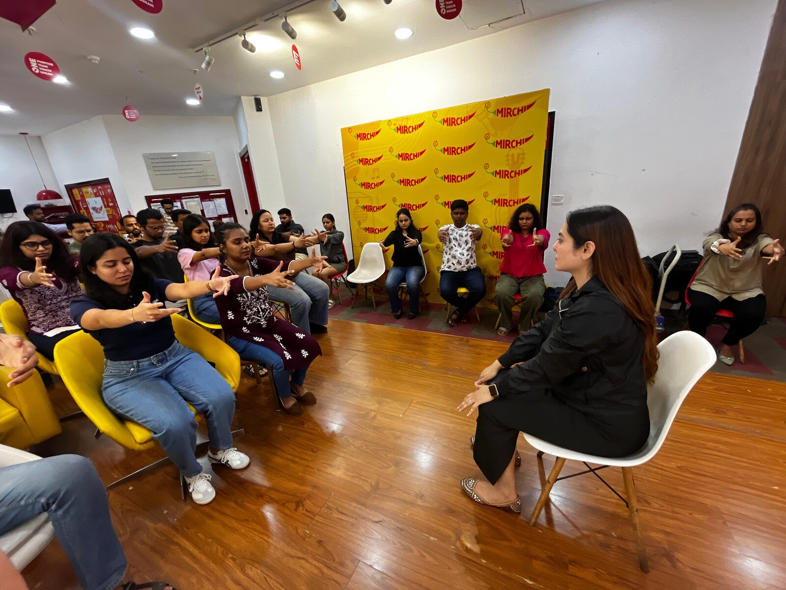 Participants seated in a semicircle during one of Vibha Jain’s group hypnotherapy sessions